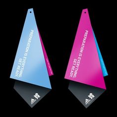 two triangular shaped plastic tags with the words protection and safety on them against a black background