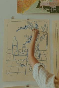 a person is drawing on a piece of paper