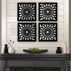 three black and white wall art pieces above a fireplace