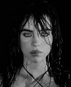 a black and white photo of a woman with wet hair