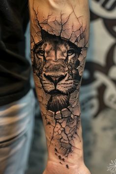 a man's arm with a lion on it and cracked glass in the background