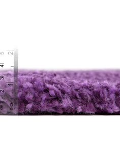 a ruler is shown next to a purple carpet