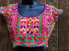 "Colorful embroidered crop top.  Hook eye closure in back. No tags - estimated size small/mediu - please see measurements. In good vintage condition.  Measurements taken across front laid flat. 17\" across front armpit to armpit or 34\" around 13.5\" across front of waist  14\" length top of shoulder to bottom" Fitted Multicolor Blouse For Festival, Multicolor Fitted Embroidered Top For Festivals, Fitted Multicolor Festival Blouse, Traditional Fitted Crop Top For Festivals, Traditional Fitted Festival Crop Top, Fitted Floral Embroidery Crop Top For Festival, Fitted Floral Embroidered Crop Top For Festival, Multicolor Fitted Cropped Top, Embroidered Short Sleeve Choli For Festivals