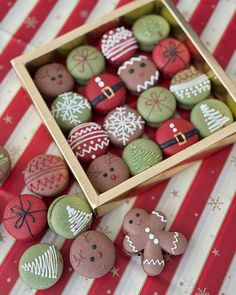 several decorated cookies in a box on a table