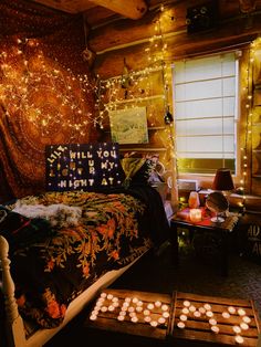 a bed room with a neatly made bed and some lights on the wall above it