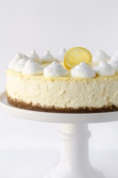 a lemon cheesecake on a white cake plate