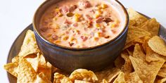 a plate topped with chips and a bowl of salsa