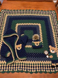 a crocheted blanket with teddy bears on it