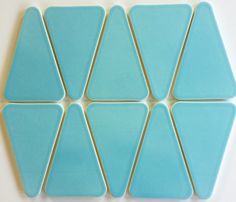 blue glass tiles arranged in the shape of hexagons on a white surface