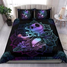 a bed with a black and purple comforter on it