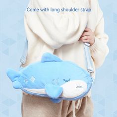 a woman holding a blue whale shaped bag with the words, come with long shoulder strap