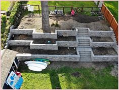 an aerial view of a backyard with concrete blocks and surfboards