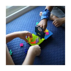 two children playing with toys on the floor