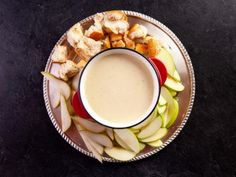 an apple and cheese plate with a cup of coffee on it, next to some sliced apples