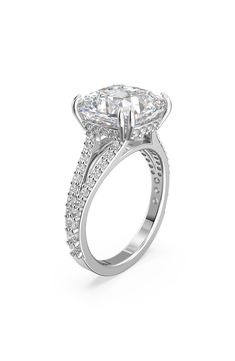 an oval cut diamond engagement ring with side stones on the band and shoulders, set in white gold