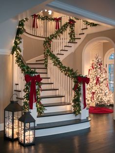 a staircase decorated with christmas garland and lights