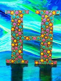 the letter h is made up of colorful beads