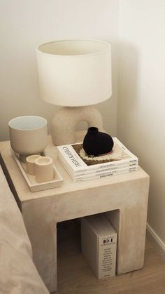 Modern Concrete side table styled with large books and a table lamp. Side Table Decor, Apartment Decor Inspiration, Room Makeover Bedroom, Room Makeover Inspiration, Decor Home Living Room, Apartment Inspiration, Room Ideas Bedroom