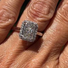 a woman's hand with an engagement ring on it, and the diamond is set in