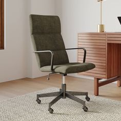 an office chair sitting on top of a rug next to a desk