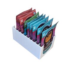 six packets of tea in a white holder