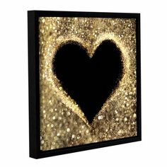 a black heart with gold glitters on it's side, framed canvas print