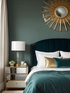 a bedroom with green walls and gold accents