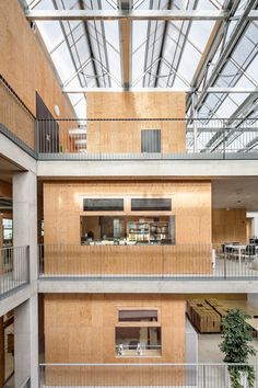 the inside of an office building with wooden walls and balconies on the second floor