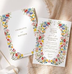 the wedding stationery is decorated with colorful flowers