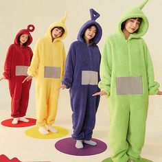 four children in animal onesuits posing for the camera with their hands on their hips