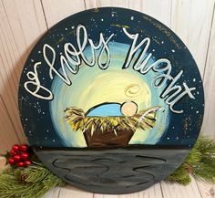 a painted sign that says happy night with a baby in a basket