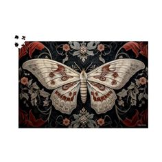 a white butterfly with red and black designs on it's wings, sitting on a floral