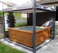 an outdoor hot tub in the middle of a yard