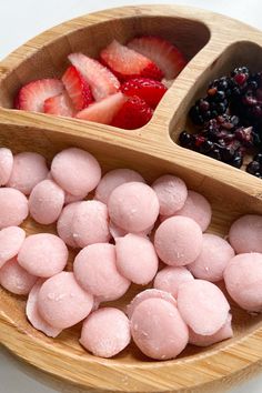 there are two bowls with different foods in them on the table, one is filled with jelly and the other has strawberries