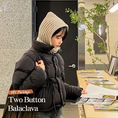 a woman standing in front of a table with magazines on it