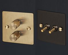 two dimmers are shown next to each other on a black wall with gold accents