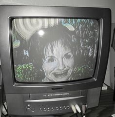 an old television sitting on top of a wooden table