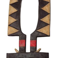 an old wooden object with red and black designs on the front, sitting against a white background