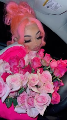 a woman with pink hair and flowers in her lap