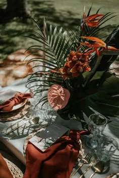 the table is set with flowers and place settings