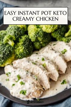 chicken and broccoli on a black plate with creamy cream sauce in the middle