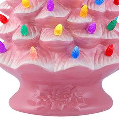 a pink vase filled with lots of colorful lights on it's sides and in the center