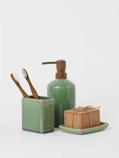 a soap dispenser, toothbrush holder and soap dish on a white background