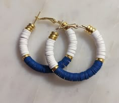 two pairs of blue and white hoop earrings with gold fittings on each earring