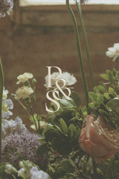 flowers and greenery in front of a window with the word p & s on it