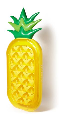 an inflatable pineapple shaped object on a white background with no people around it