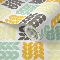 a close up view of a wallpaper with leaves and circles in yellow, green, gray, and white colors