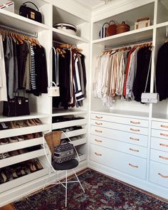 an organized closet with white cabinets and drawers