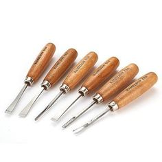 six wood handled knives with wooden handles and metal tips are lined up in a row