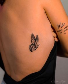 a woman with a butterfly tattoo on her left side ribcage and the word mia written in cursive writing